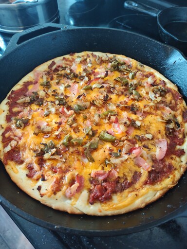a pizza cooked in a cast iron pan
