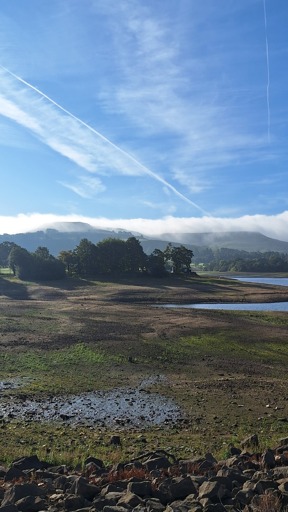 Morning photo showing mist hanging over the top of two hills in the peak district UK.